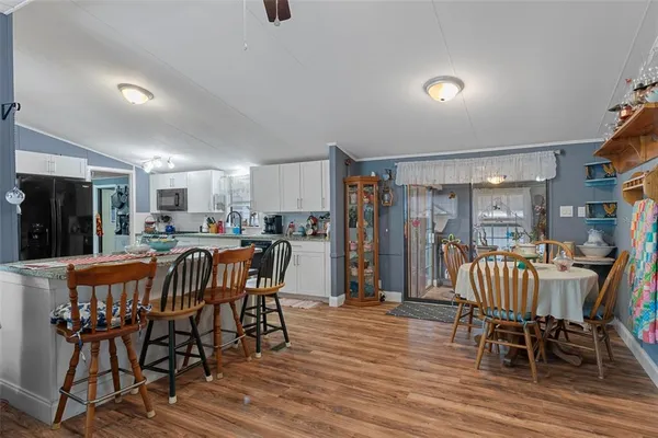 a view of a dining room with furniture and wooden floor