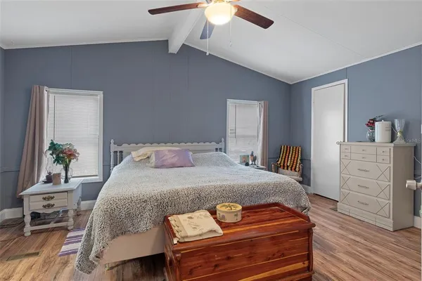 a bedroom with a bed and a dresser in it