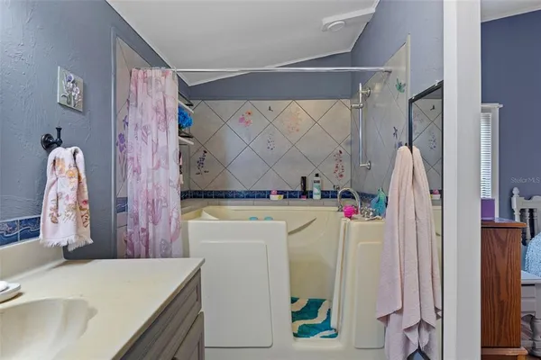 a bathroom with a sink vanity and a mirror