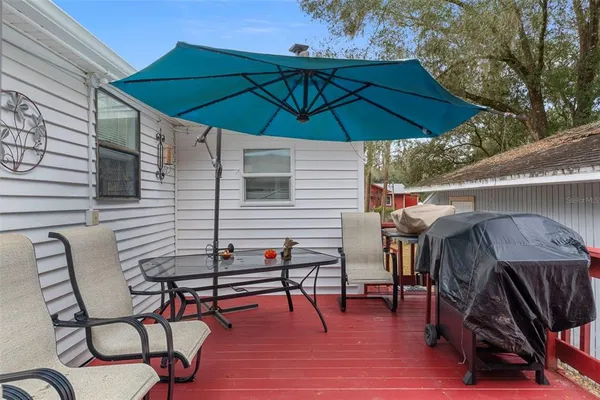 a view of a house with a yard and sitting area
