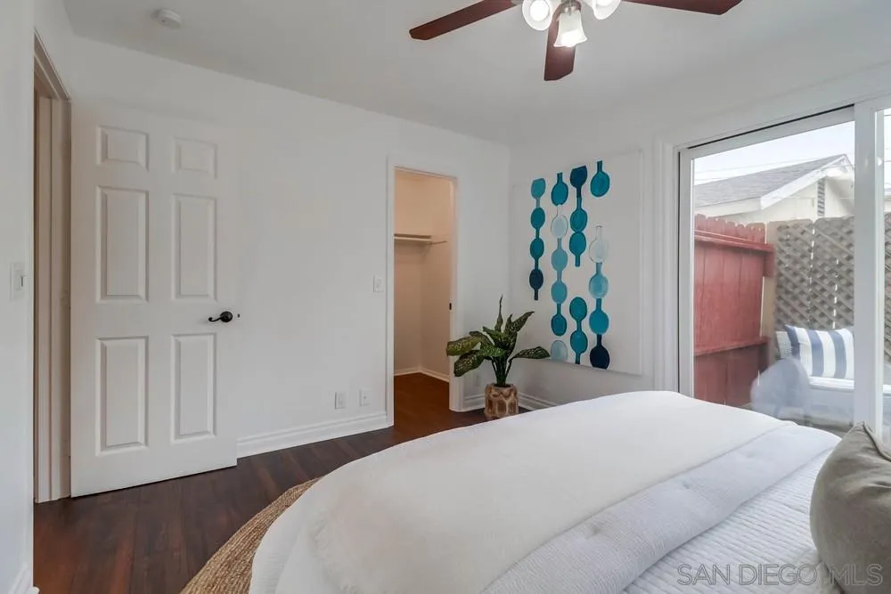 4375 Felton Street, Unit 3 San Diego, CA 92104 - Photo 17 of 27 a bedroom with a large bed and a chandelier