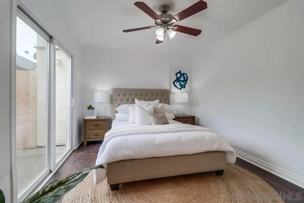 4375 Felton Street, Unit 3 San Diego, CA 92104 - Photo 18 of 27 a bedroom with a bed and a chandelier