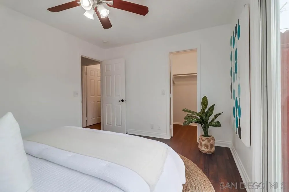 4375 Felton Street, Unit 3 San Diego, CA 92104 - Photo 19 of 27 a bedroom with a large bed and a chandelier