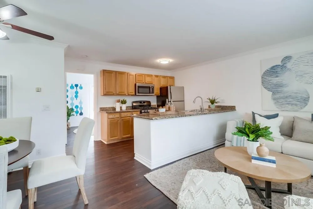 4375 Felton Street, Unit 3 San Diego, CA 92104 - Photo 8 of 27 a kitchen with granite countertop a white refrigerator a stove a dining table and chairs