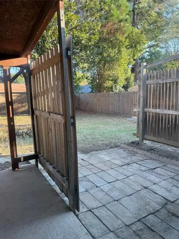 a view of a backyard with wooden fence