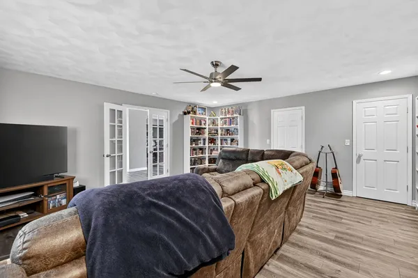 a bed room with a bed television and a window