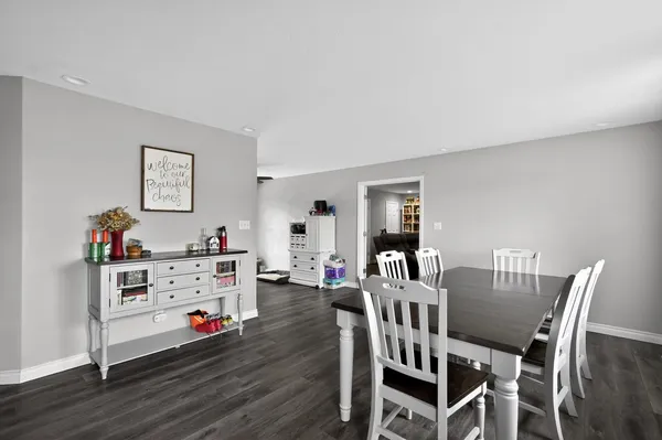a view of a dining room with furniture and wooden floor