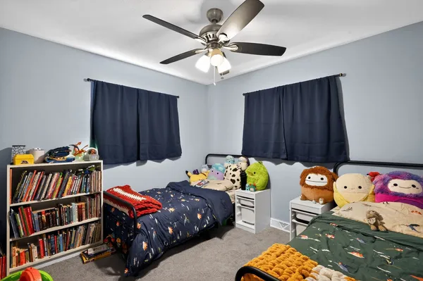 a bedroom with a bed and a baby crib