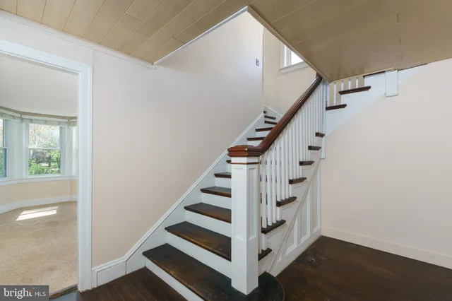 a view of entryway with wooden floor and stairs