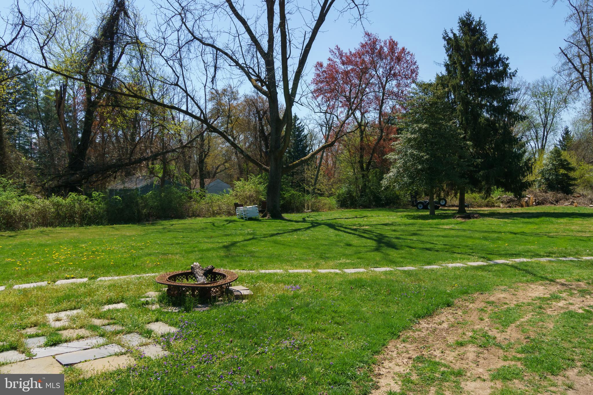 124 Washington Road, Unit 2 Princeton Junction, NJ 08540 - Photo 18 of 18 a backyard of a house with table and chairs plants and trees