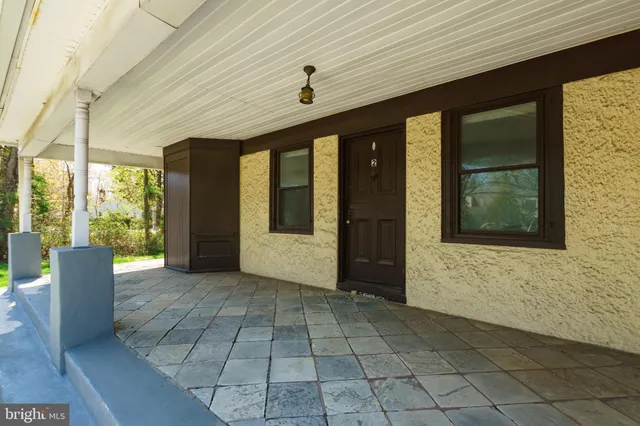 a front view of a house with a large window