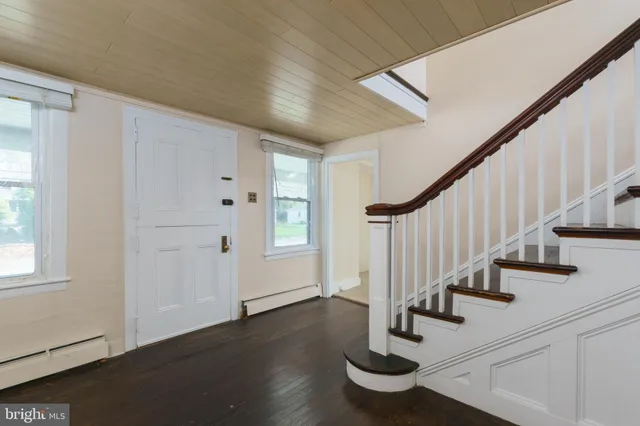 a view of entryway with wooden floor and stairs