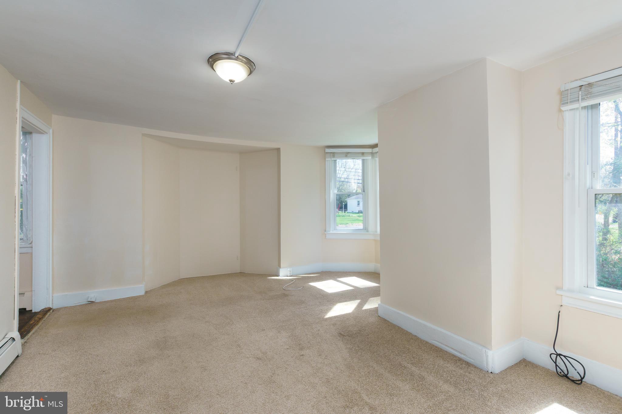 124 Washington Road, Unit 2 Princeton Junction, NJ 08540 - Photo 4 of 18 a view of an empty room with a window