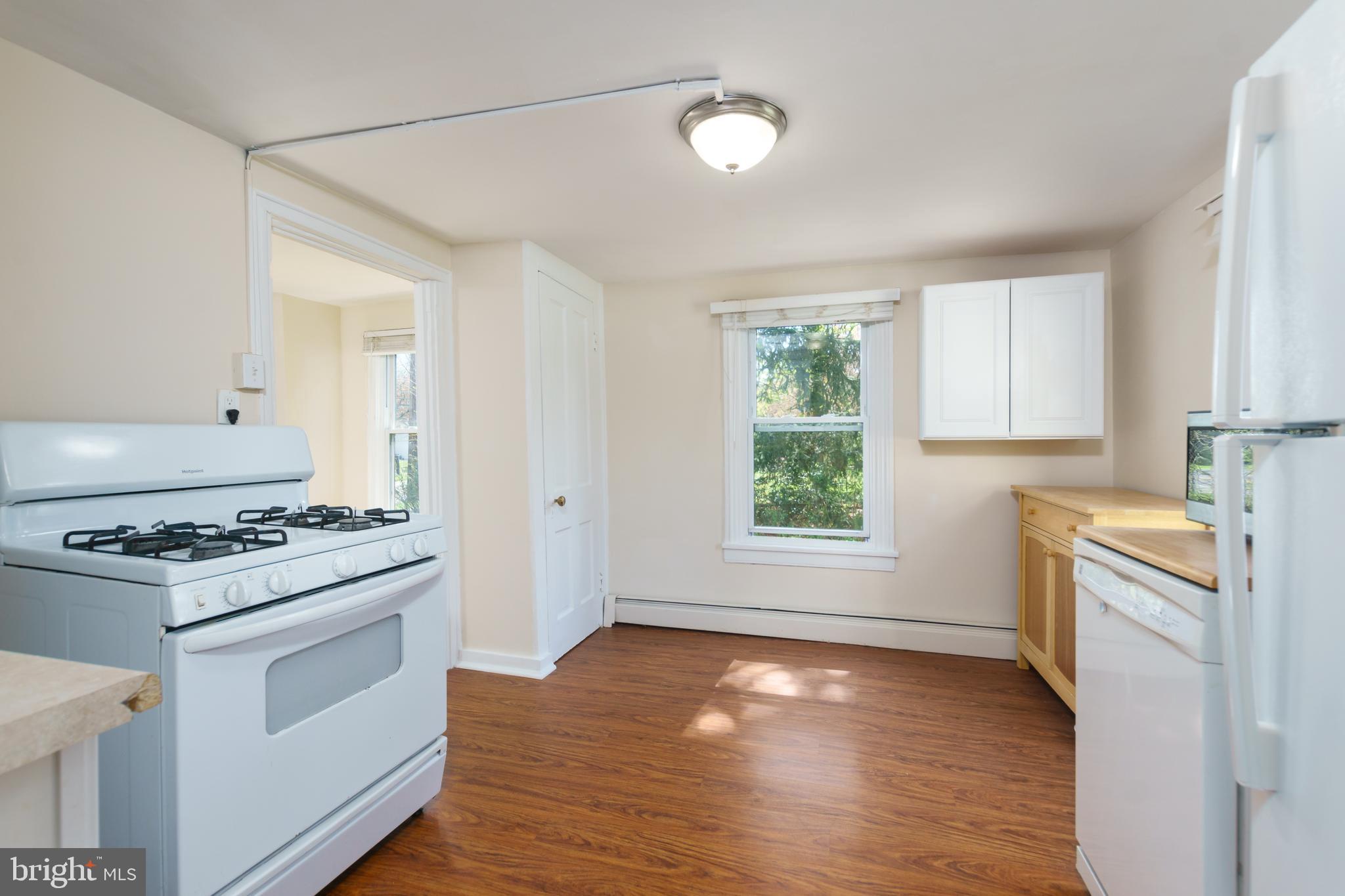 124 Washington Road, Unit 2 Princeton Junction, NJ 08540 - Photo 6 of 18 a kitchen with a stove a sink and a refrigerator