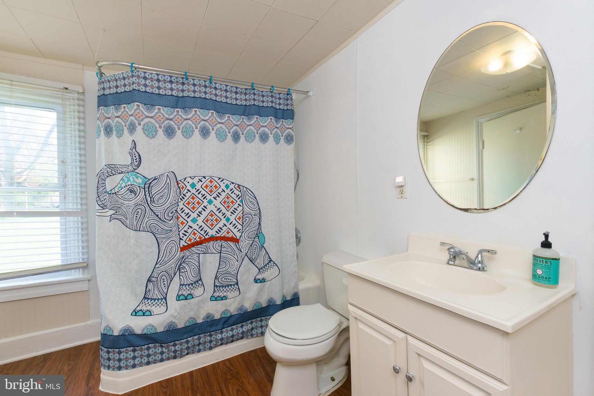 124 Washington Road, Unit 2 Princeton Junction, NJ 08540 - Photo 8 of 18 a bathroom with a toilet a sink and a mirror