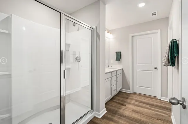 a bathroom with a shower and a tub