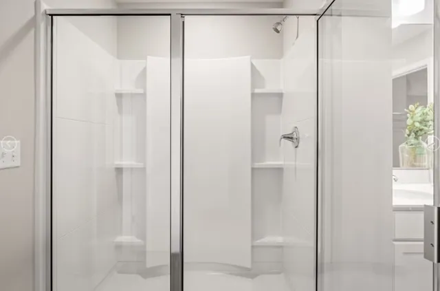 a bathroom that has a glass shower door