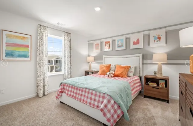 a bedroom with a bed lamp and a window