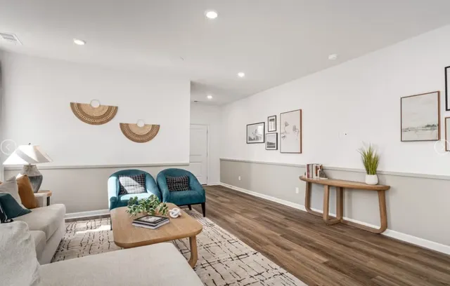 a living room with furniture and wooden floor
