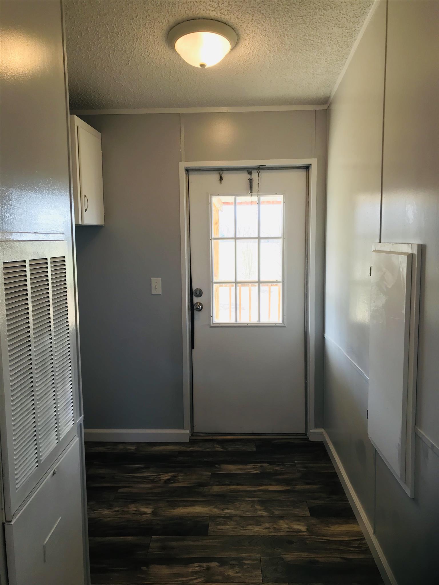145 Absher Road Portland, TN 37148 - Photo 17 of 22 a view of an empty room with wooden floor and a window