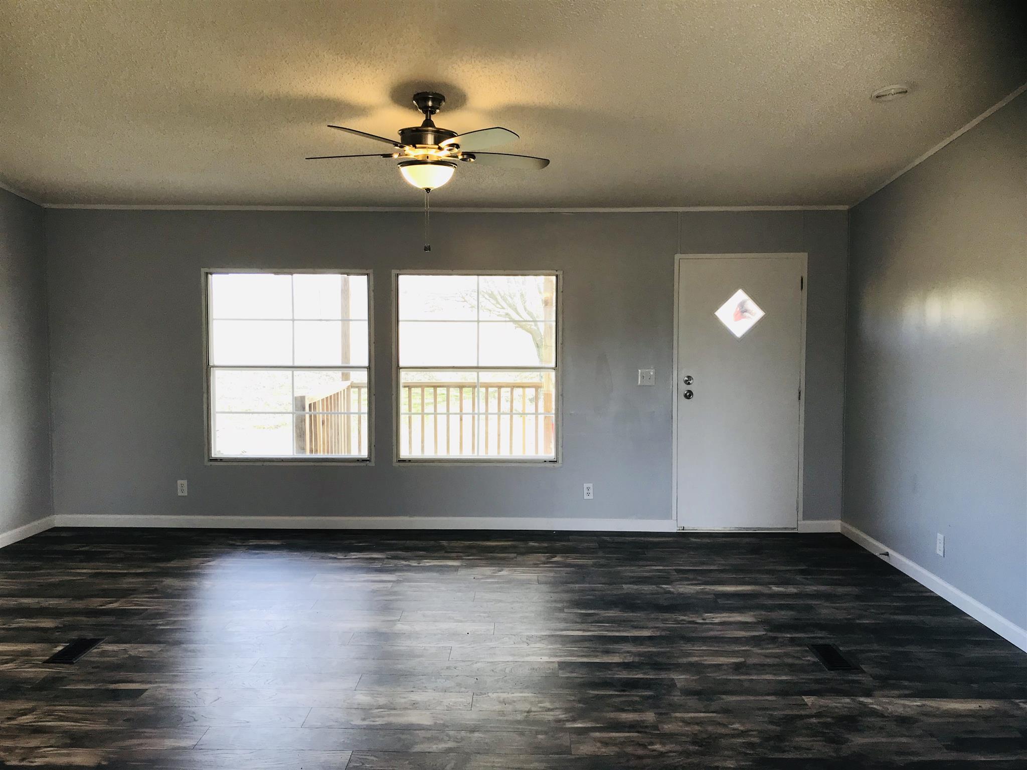 145 Absher Road Portland, TN 37148 - Photo 2 of 22 a view of an empty room with wooden floor and a window