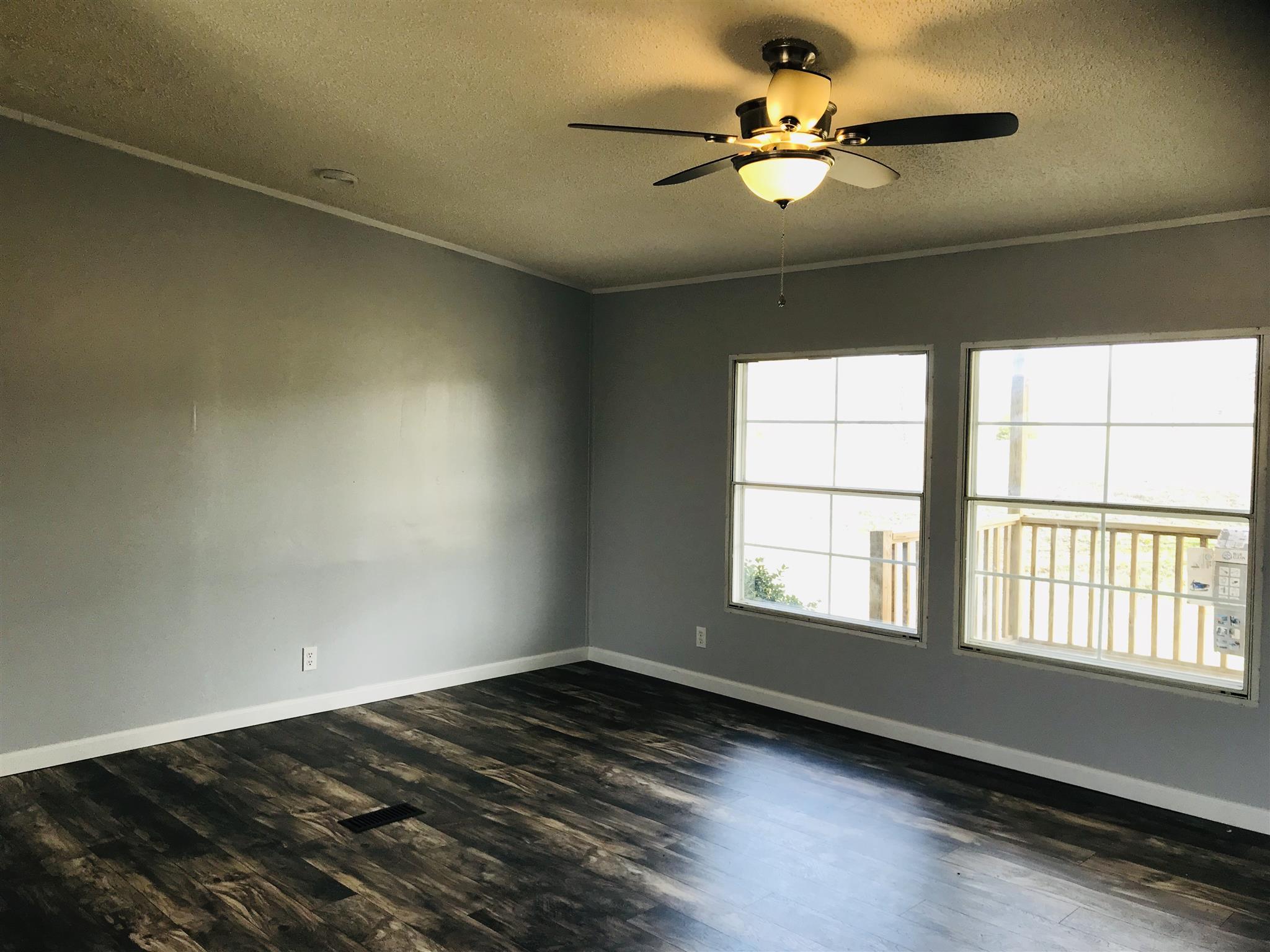 145 Absher Road Portland, TN 37148 - Photo 3 of 22 wooden floor in an empty room with a window