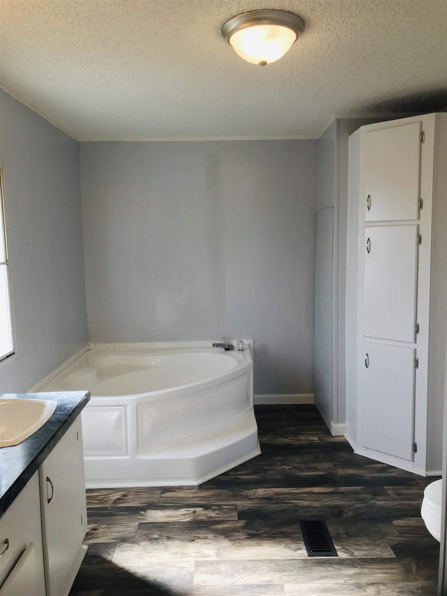 145 Absher Road Portland, TN 37148 - Photo 9 of 22 a bathroom with a tub and sink