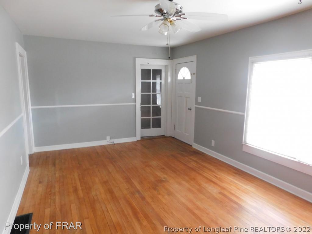 426 Camp Easter Road Carthage, NC 28327 - Photo 5 of 31 an empty room with wooden floor fan and windows