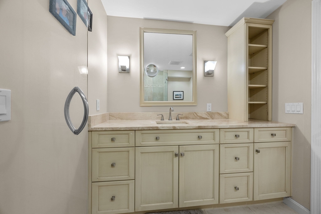 381 Great Oak Road, Unit 9 Mashpee, MA 02649 - Photo 21 of 42 a bathroom with a granite countertop sink and a mirror