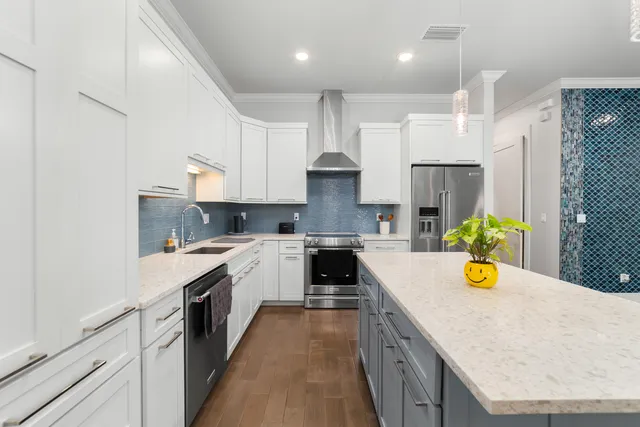 a kitchen with a sink a counter top space stainless steel appliances and cabinets