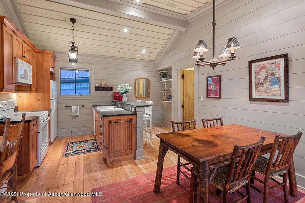 777 Old Herron Road Basalt, CO 81621 - Photo 20 of 43 a kitchen that has a table chairs and wooden floor