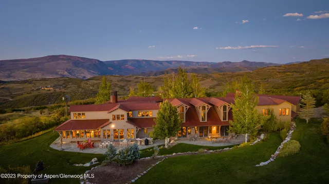a view of a house with a yard and mountain