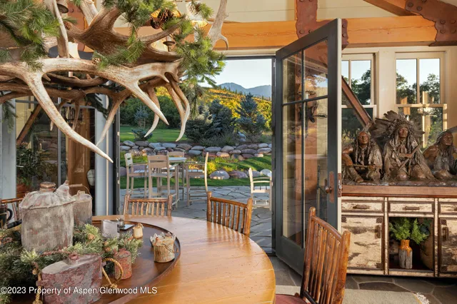 a view of a chairs and table in patio with a barbeque grill