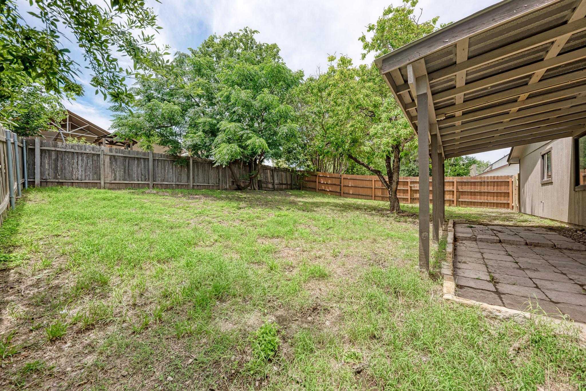 12108 Carnforth Drive Austin, TX 78753 - Photo 30 of 33 a view of a backyard with a tree