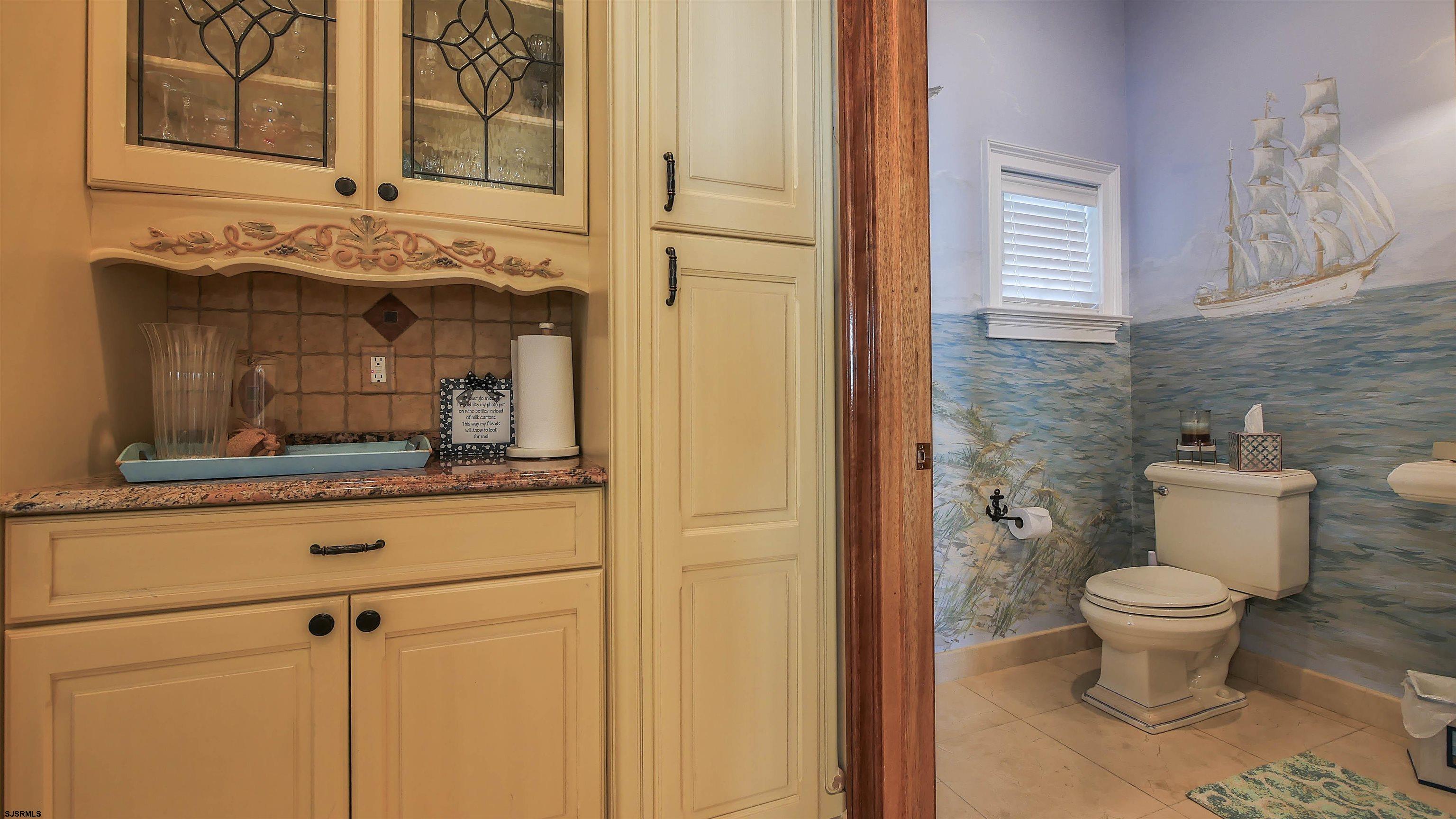 530 West Shore Drive, Unit DIRECT BAYFRONT Brigantine, NJ 08203 - Photo 15 of 63 a bathroom with a toilet sink and mirror