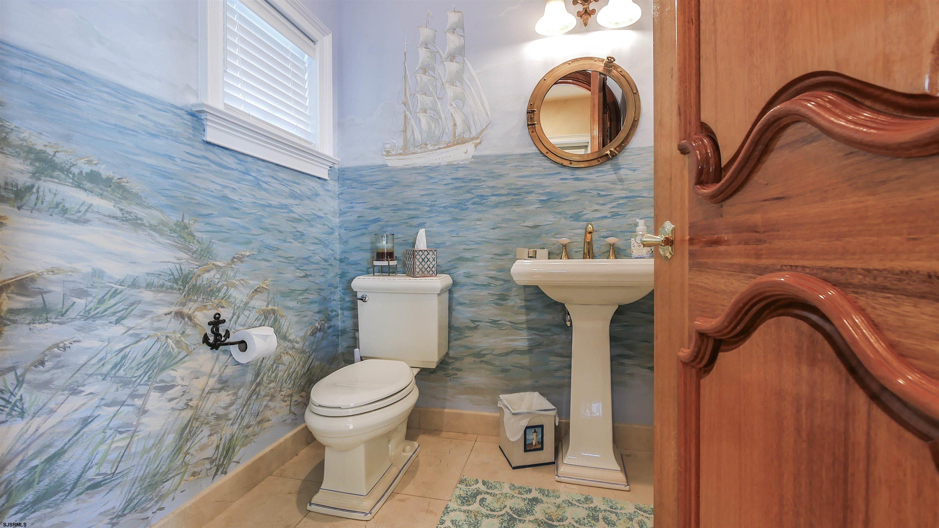 530 West Shore Drive, Unit DIRECT BAYFRONT Brigantine, NJ 08203 - Photo 16 of 63 a bathroom with a toilet sink and mirror
