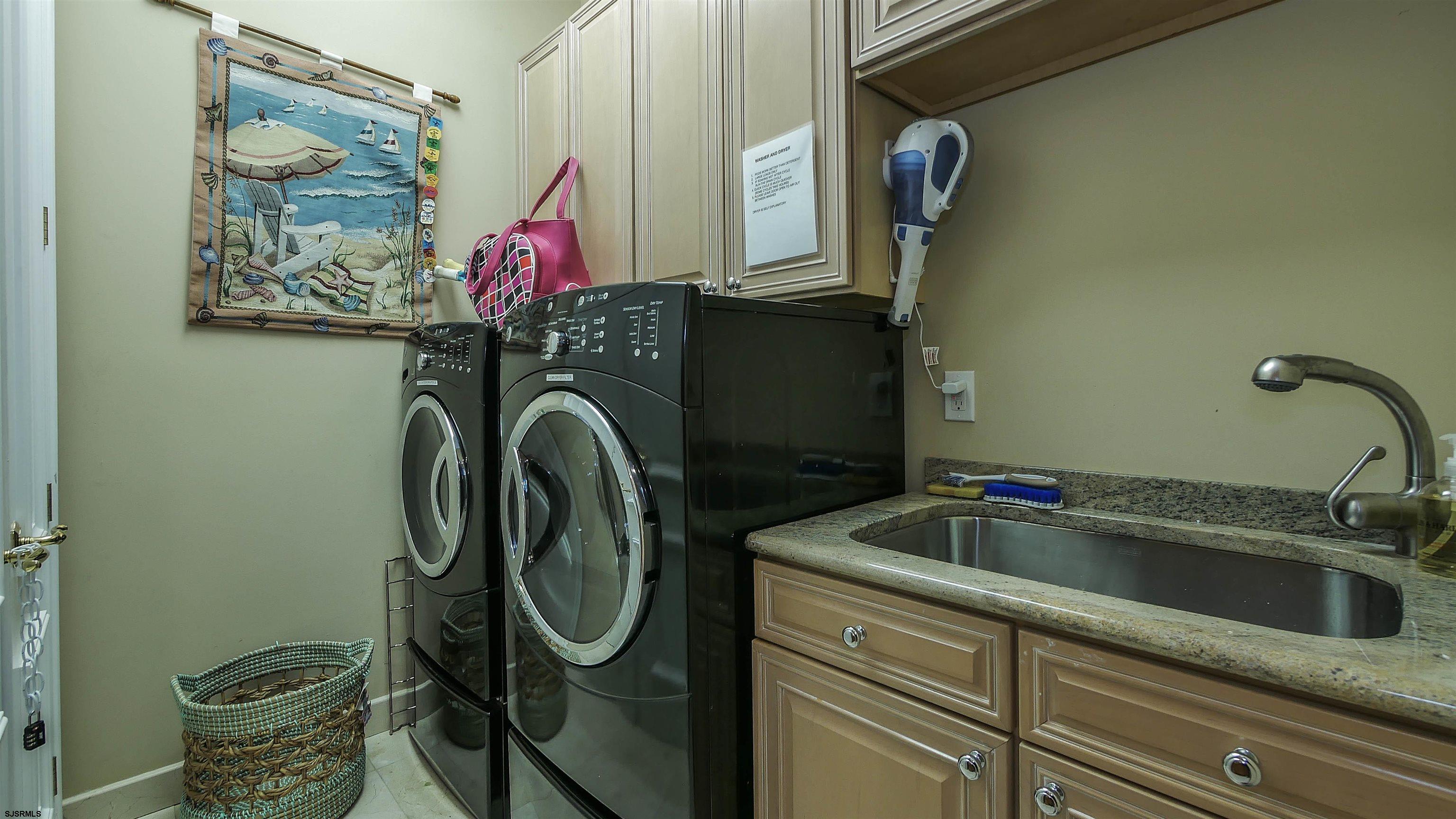 530 West Shore Drive, Unit DIRECT BAYFRONT Brigantine, NJ 08203 - Photo 23 of 63 a utility room with dryer and washer