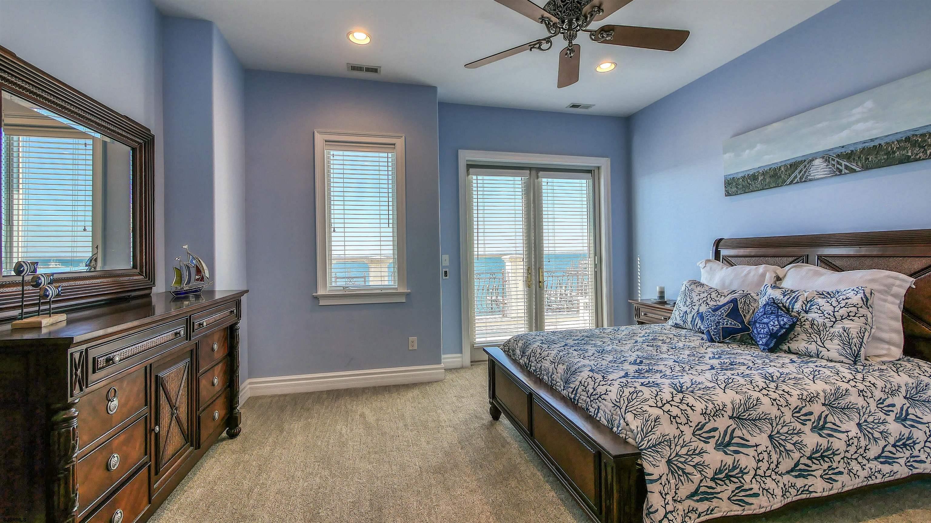 530 West Shore Drive, Unit DIRECT BAYFRONT Brigantine, NJ 08203 - Photo 29 of 63 a bedroom with a bed and a chandelier