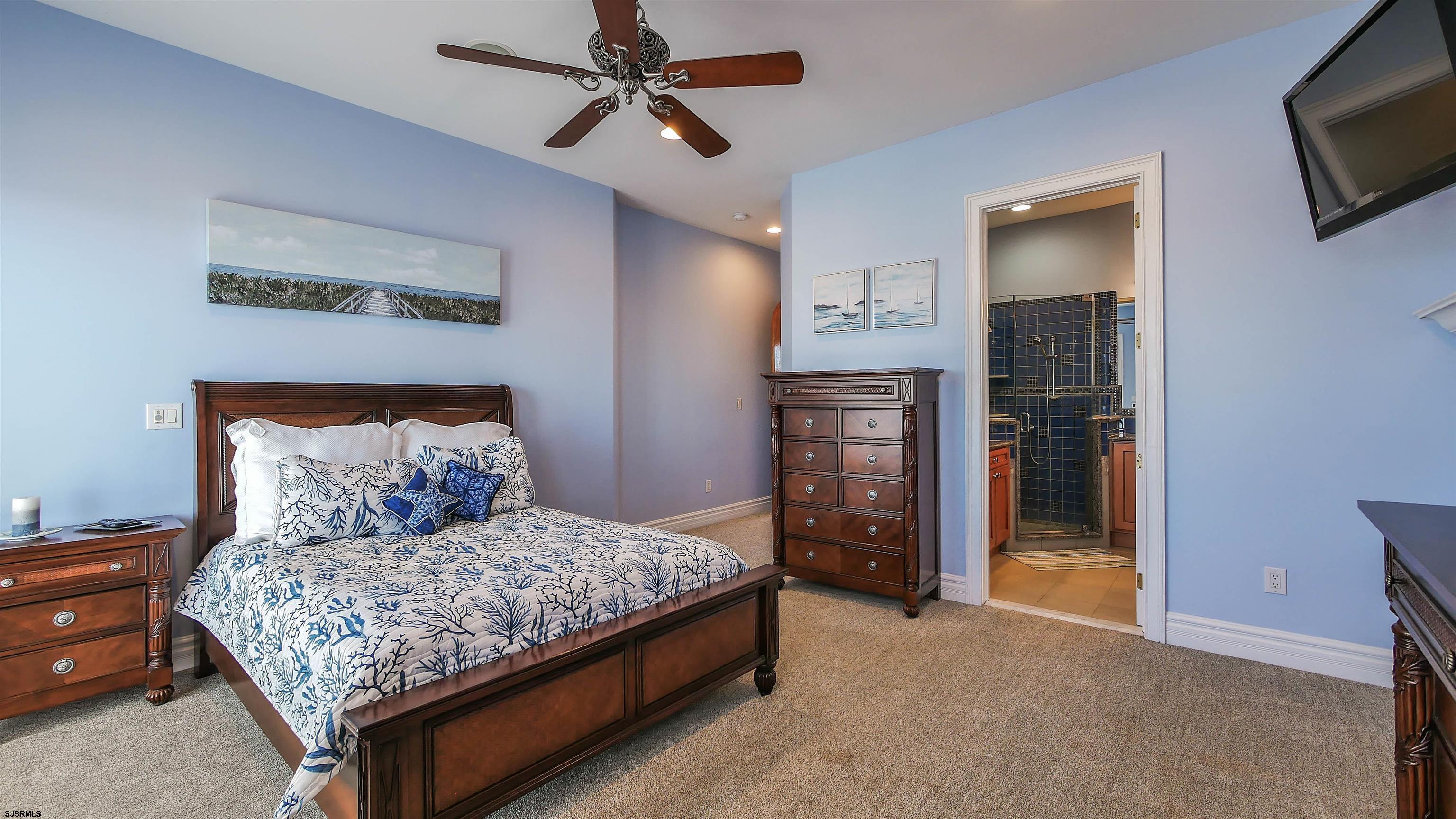 530 West Shore Drive, Unit DIRECT BAYFRONT Brigantine, NJ 08203 - Photo 30 of 63 a room with a bed and a television