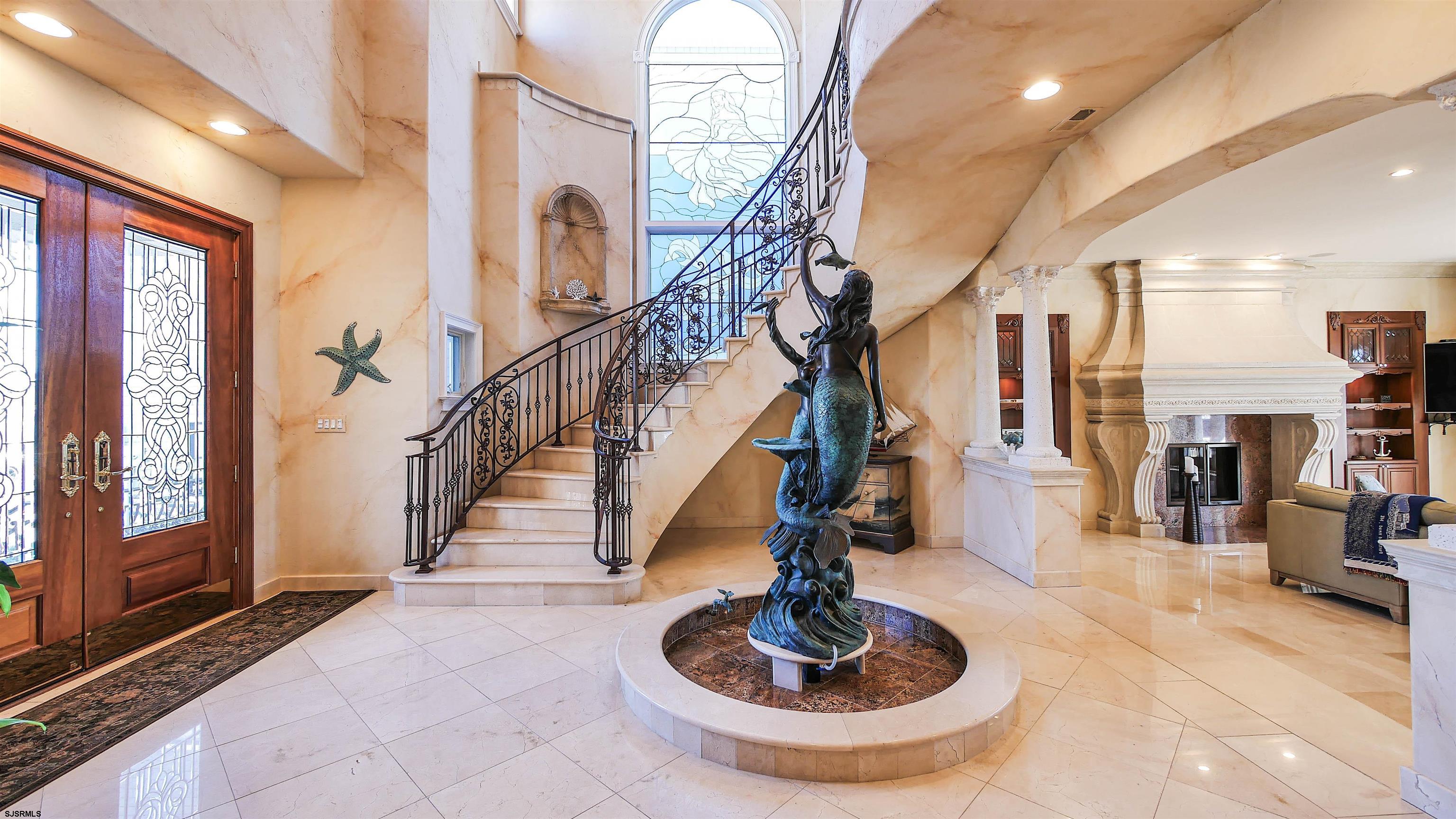 530 West Shore Drive, Unit DIRECT BAYFRONT Brigantine, NJ 08203 - Photo 3 of 63 a living room with lots of furniture and a chandelier