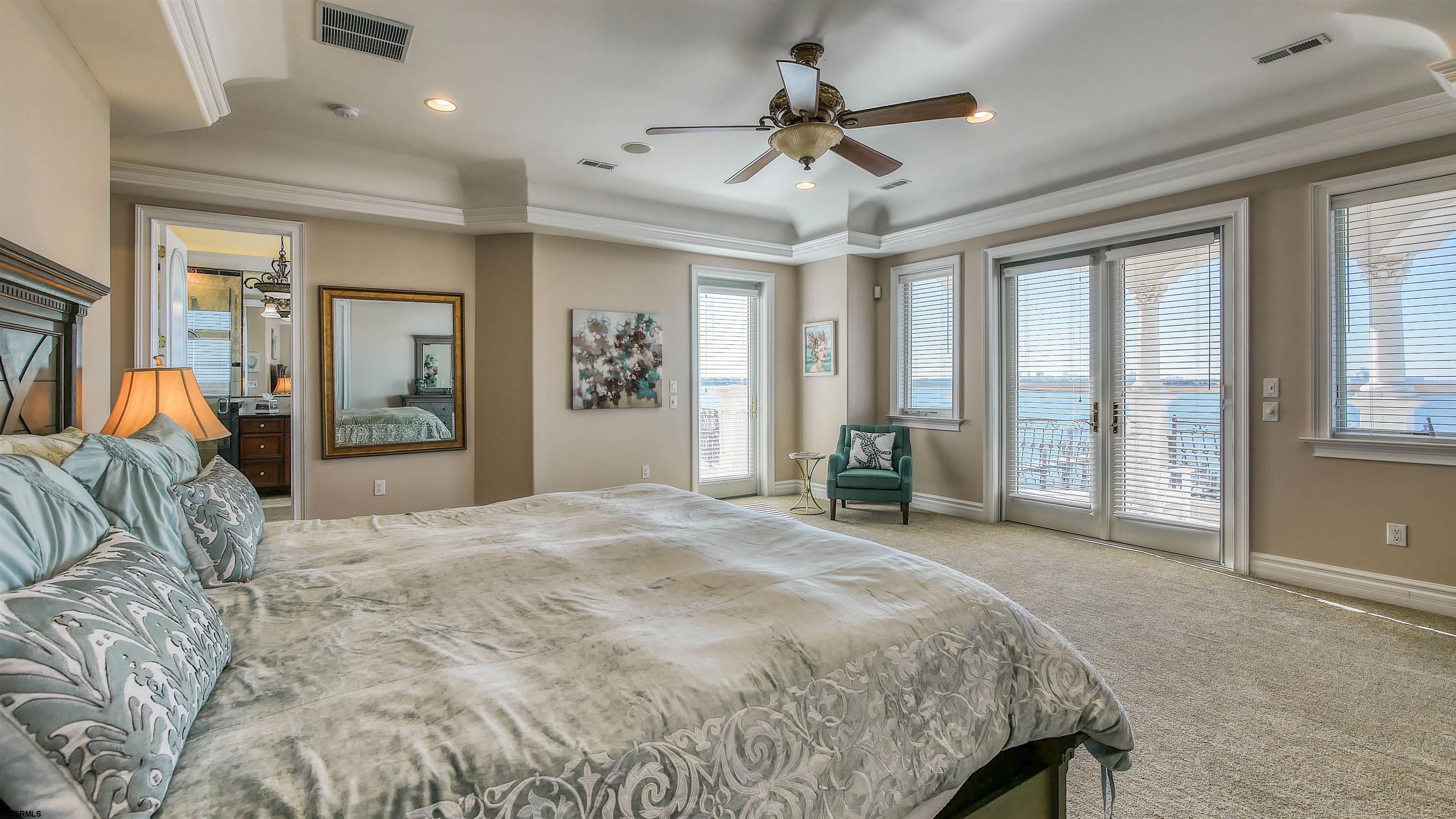 530 West Shore Drive, Unit DIRECT BAYFRONT Brigantine, NJ 08203 - Photo 42 of 63 a spacious bedroom with a large bed and a large window