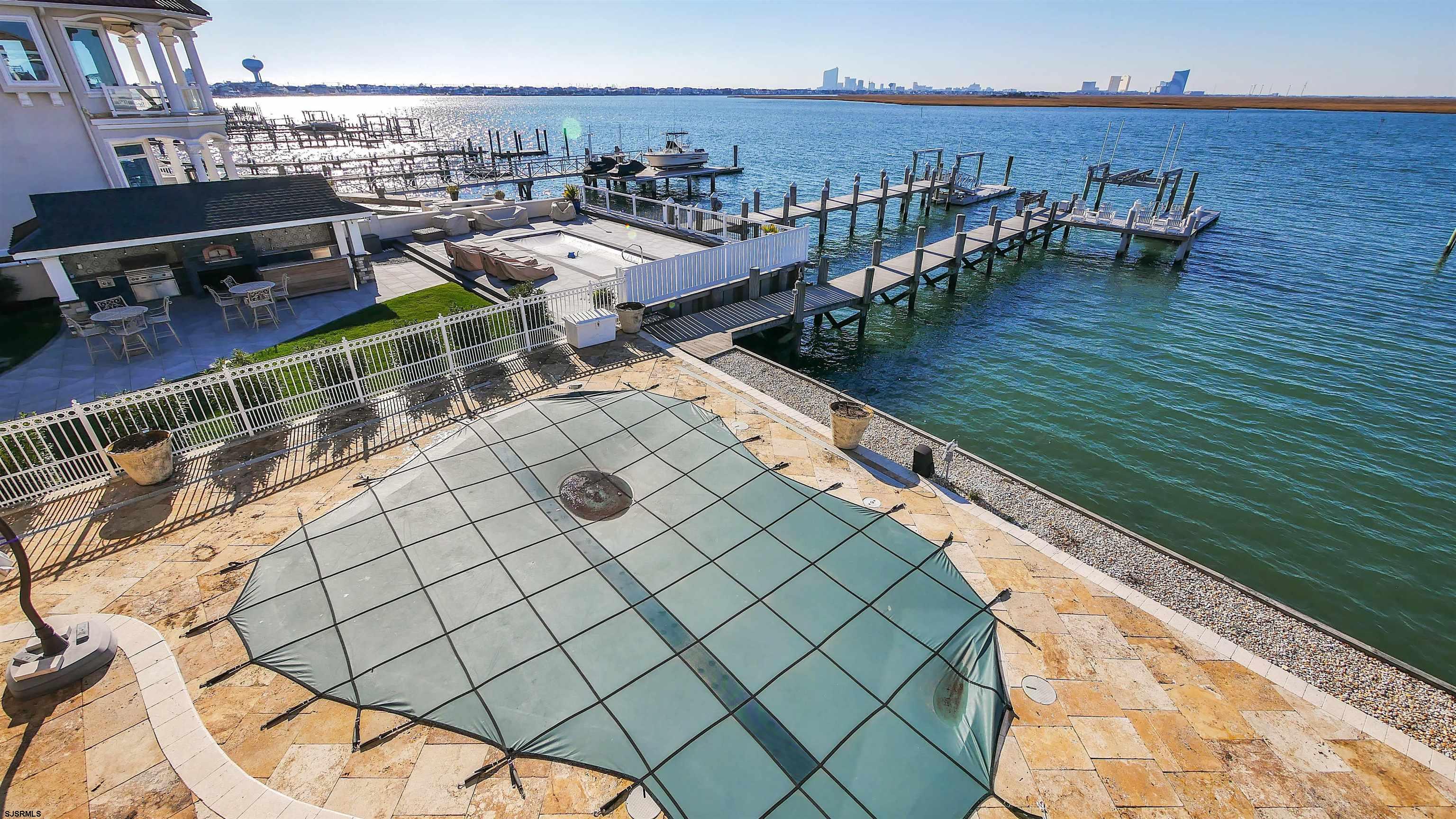 530 West Shore Drive, Unit DIRECT BAYFRONT Brigantine, NJ 08203 - Photo 46 of 63 a view of a balcony with an outdoor seating