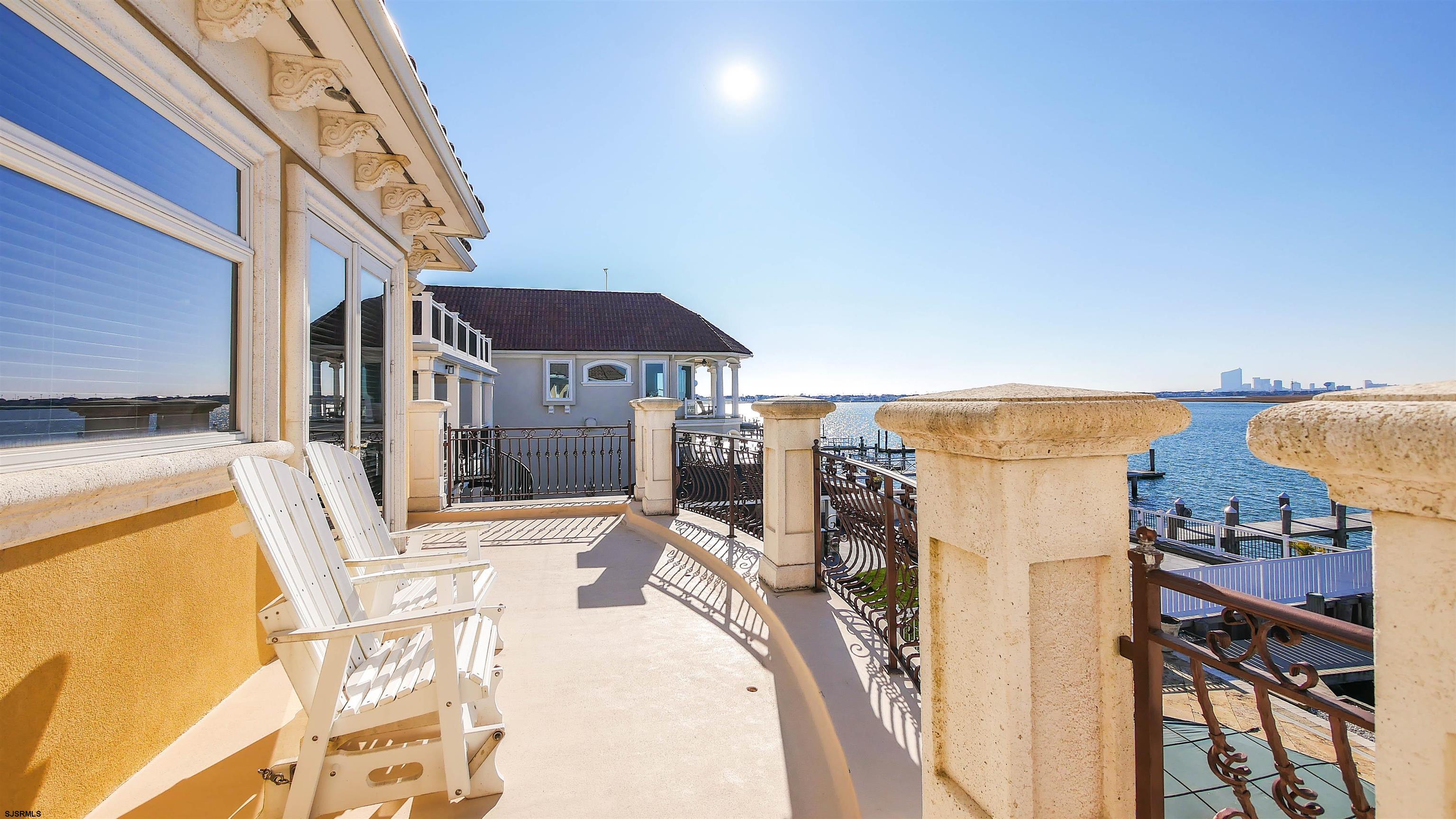 530 West Shore Drive, Unit DIRECT BAYFRONT Brigantine, NJ 08203 - Photo 48 of 63 a view of a terrace with chairs