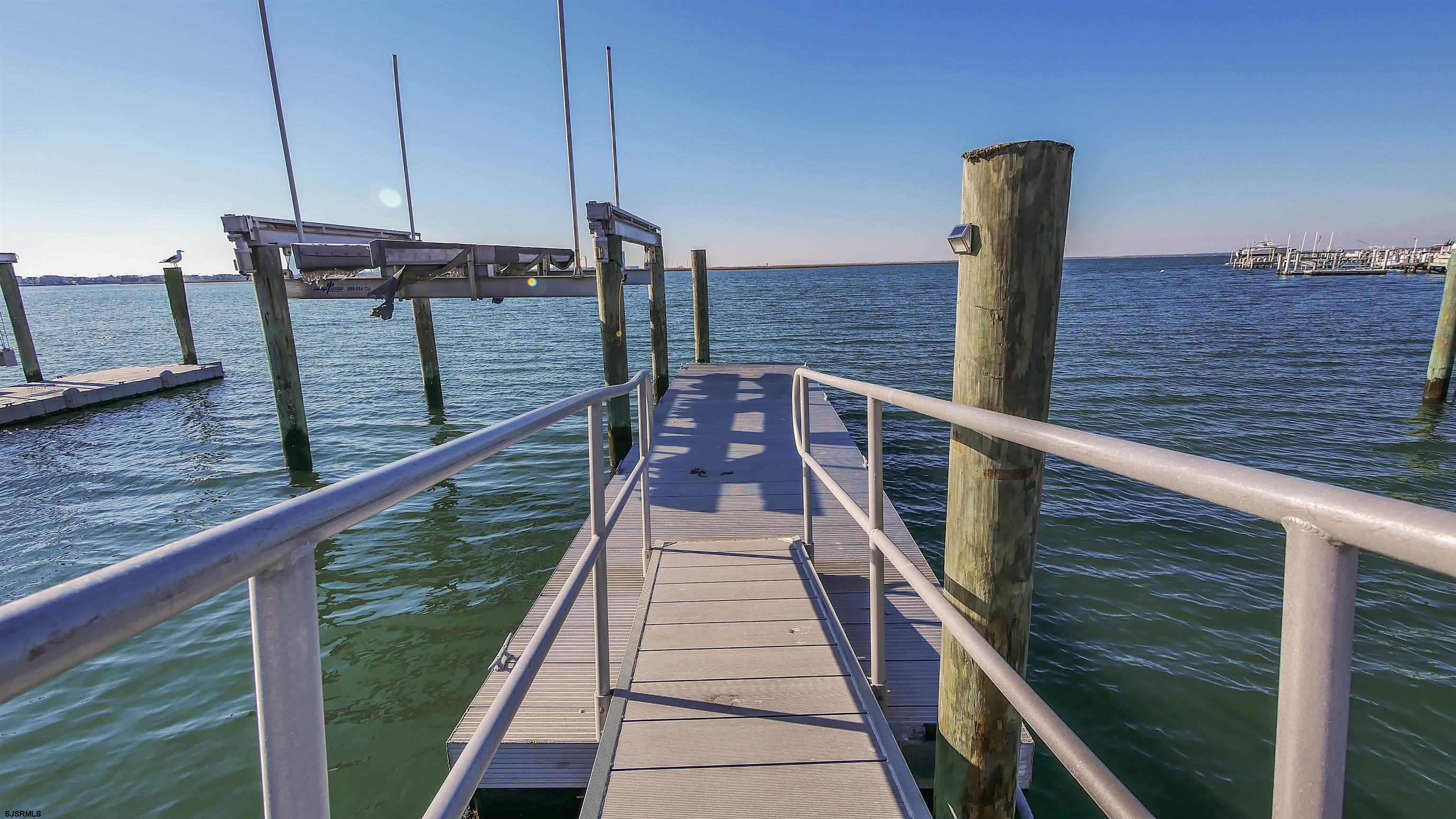 530 West Shore Drive, Unit DIRECT BAYFRONT Brigantine, NJ 08203 - Photo 60 of 63 a view of a balcony with two chairs