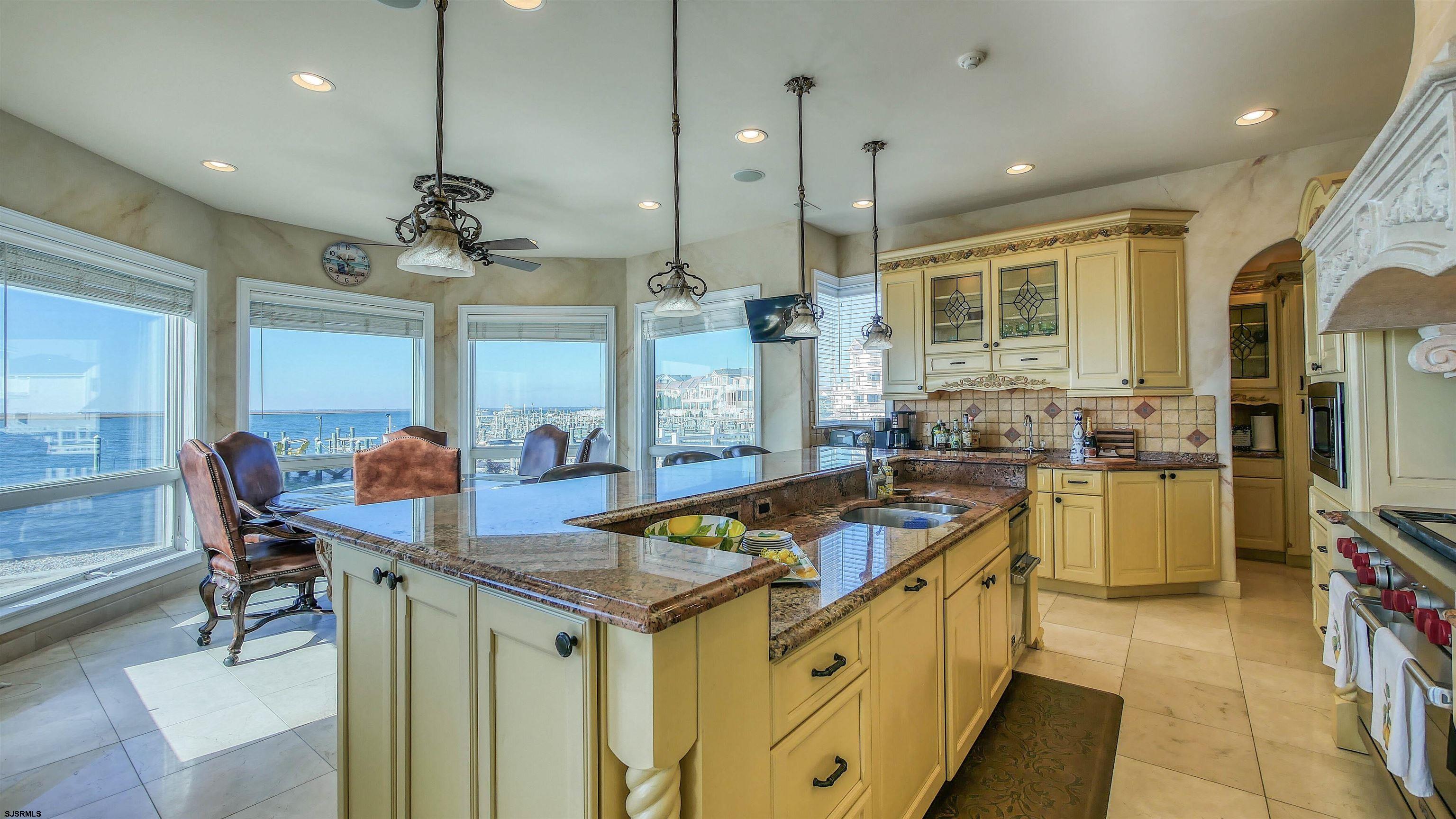 530 West Shore Drive, Unit DIRECT BAYFRONT Brigantine, NJ 08203 - Photo 9 of 63 a kitchen with stainless steel appliances granite countertop a sink a stove and a refrigerator