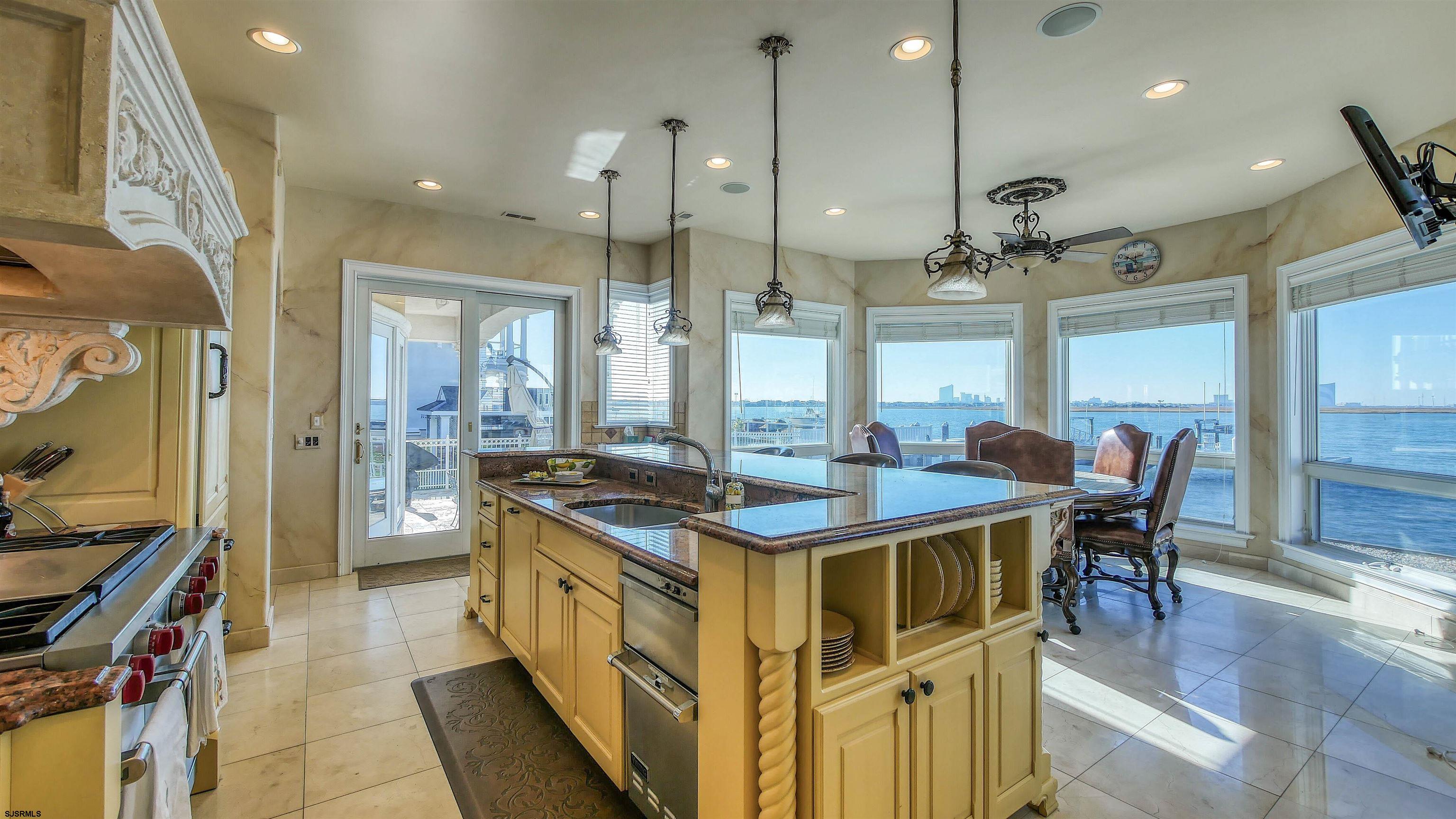 530 West Shore Drive, Unit DIRECT BAYFRONT Brigantine, NJ 08203 - Photo 10 of 63 a kitchen with stainless steel appliances granite countertop a stove and a wooden floors