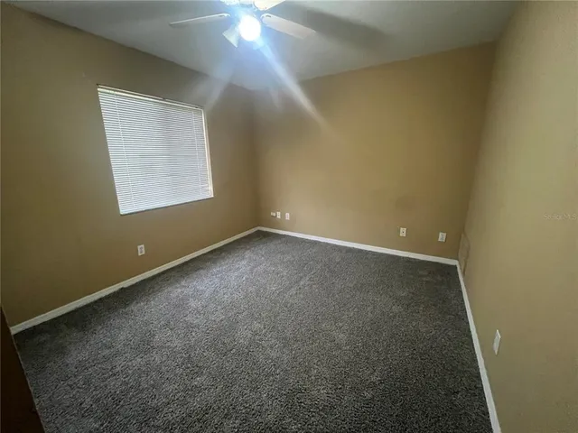 an empty room with a empty space and windows