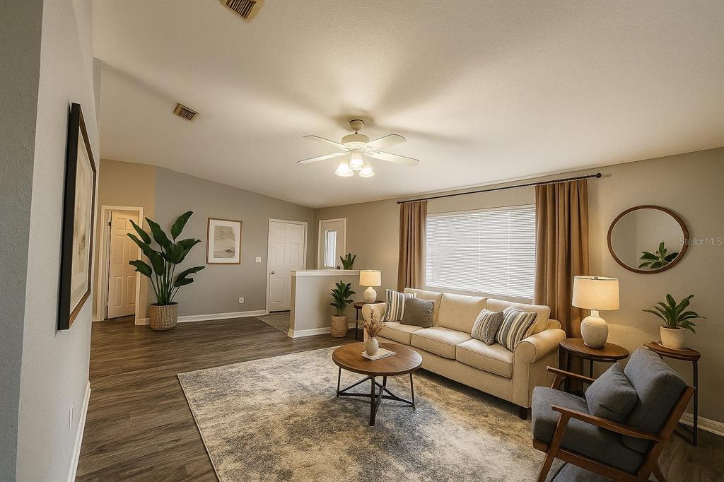 6070 Southwest 99th Place Ocala, FL 34476 - Photo 2 of 19 a living room with furniture ceiling fan and a rug