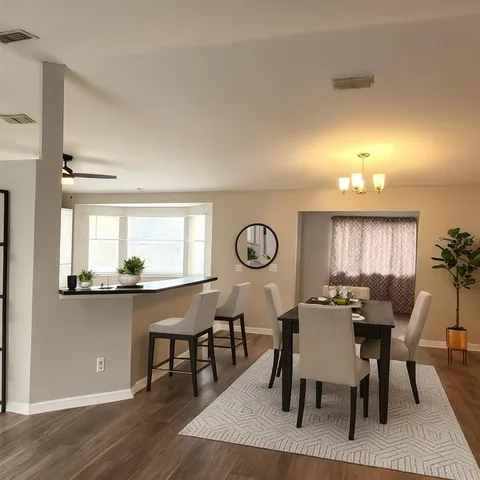 a view of a dining room with furniture window and wooden floor