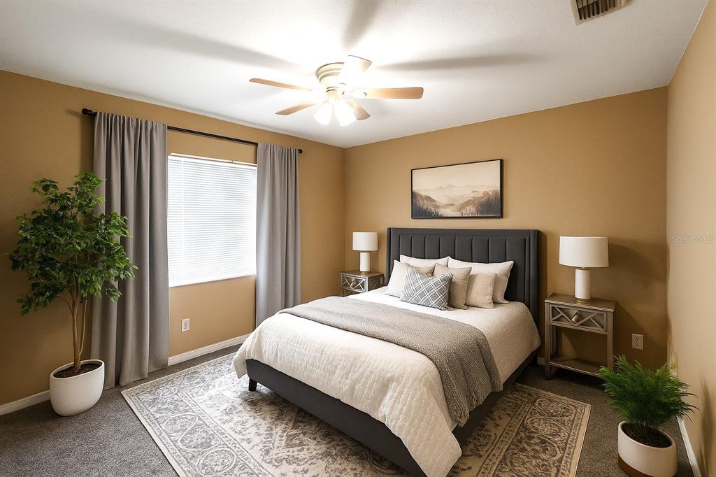 6070 Southwest 99th Place Ocala, FL 34476 - Photo 8 of 19 a bedroom with a large bed and a potted plant